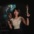 Dr Chen Mao Davies holds up her BAFTA and Oscar awards - Anya baby & breastfeeding app