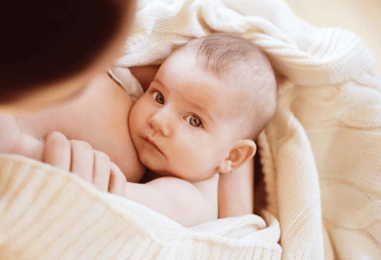 New baby & mother in a blanket - Anya baby & breastfeeding app