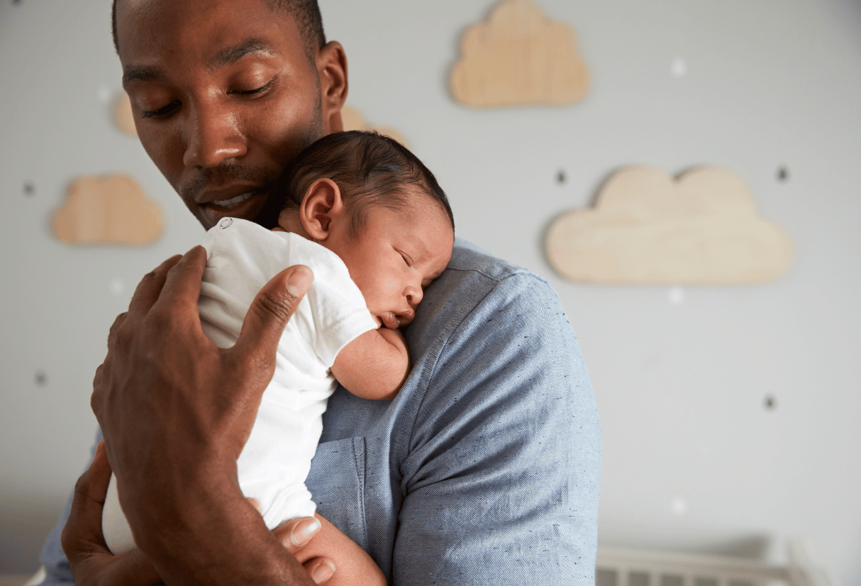 A dad holds his newborn baby - Anya baby & breastfeeding app