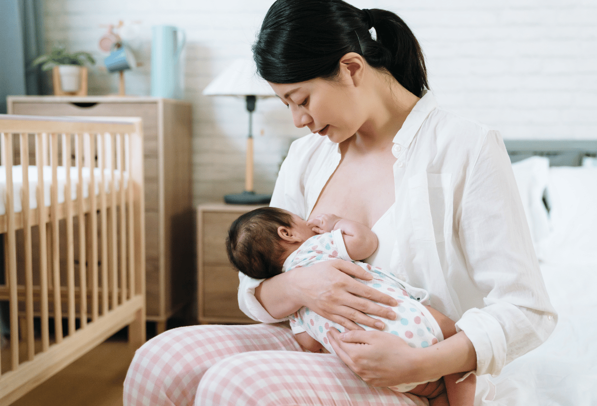 A mother breastfeeds in her nursery at home - Anya baby & breastfeeding app