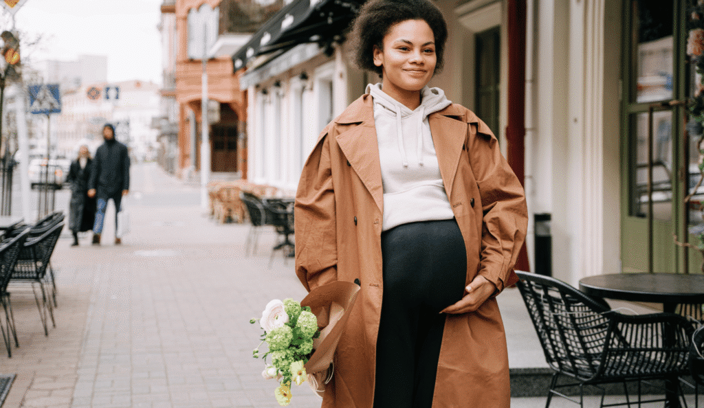 pregnant woman walking down street in winter
